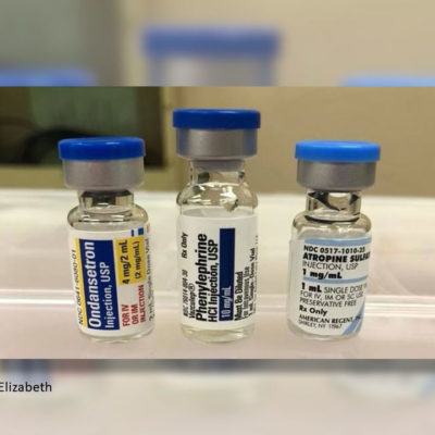 Phenylephrine 1% 1mL vial paired next to Ondansetron (Zofran®) 4mg 2mL vial and Atropine sulfate 1mg/mL vials. Look-alike with blue tops.