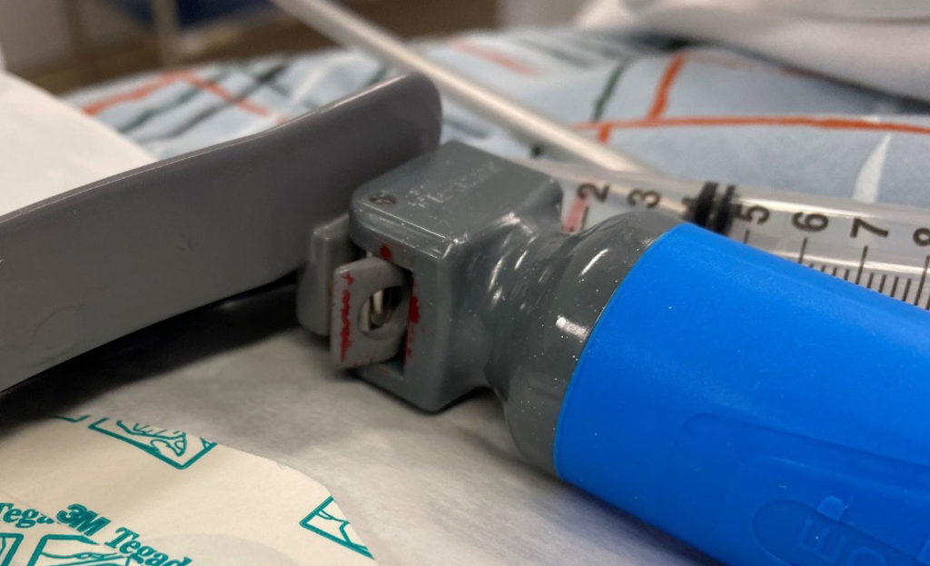 Figure 1: Blood noticed on the blade and handle of the disposable laryngoscope.