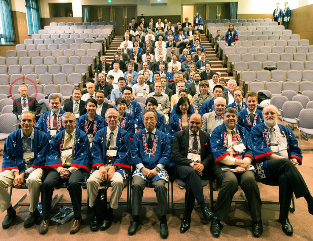 Figure 3: 2015 Tokyo IAMPOV Symposium (Last day, Auditorium at St. Luke’s International University)—An international symposium on patient monitoring devices and technology related to circulation, oxygenation, and respiration. Left side in red circle: Takuo Aoyagi. Central area, front row from left to right: P. Bickler (UCSF), S. Weininger (FDA), S. Barker (Masimo) K. Miyasaka (St. Luke’s), P. Kyriacou (U. London), B. Kopotic (Edwards), K. Shelley (Yale).