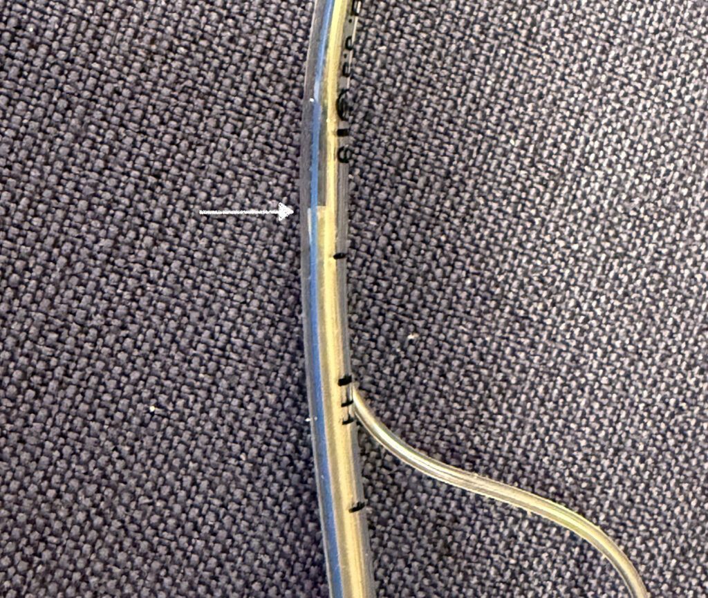 Figure 4. Endotracheal tube patency. Multiple 2.5 endotracheal tubes were found not to allow for passage of a size 5/6 French suction catheter. This appears to be due to a manufacturing defect where the pilot line inserts into the endotracheal tube (arrow).